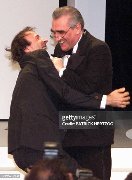 Director and Jury president Martin Scorsese holds Italian director Roberto Benigni after he was awarded with the Grand Prix for his film " La Vita e...