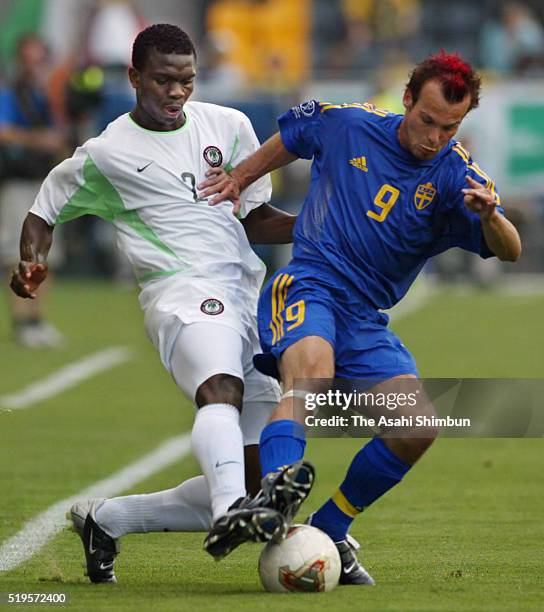 Fredrik Ljungberg of Sweden and Joseph Yobo of Nigeria compete for the ball during the FIFA World Cup Korea/Japan Group F match between Sweden and...