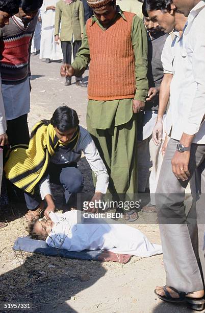 Picture dated 04 December 1984, shows men surrounding the body of a young victim of the Bhopal tragedy. A poison gas leak from the Union Carbide...