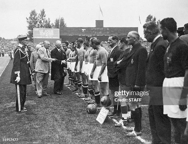 French president Albert Le Brun shakes hand with the Italian players 19 June 1938 in Colombes, in the suburbs of Paris, before the start of the World...