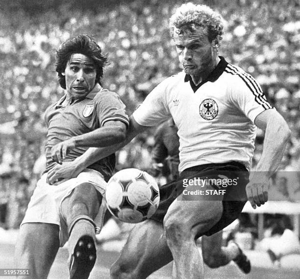Italian forward Bruno Conti battles for the ball with West German midfielder Hans Peter Briegel 11 July 1982 in Madrid during the World Cup soccer...