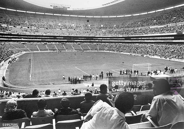 Soccer fans watch a match in progress 21 April 1970 at the Azteca stadium in Mexico City. The stadium which has a capacity of 110.000 spectators will...