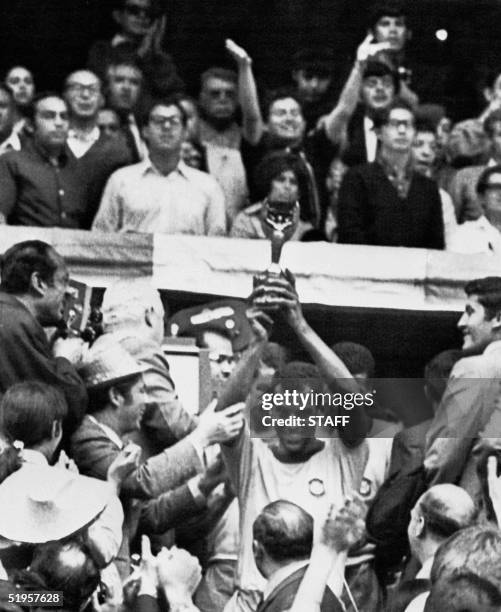 Brazilian national soccer team captain and defender Carlos Alberto smiles as he holds aloft the Jules Rimet Cup after Brazil defeated Italy 4-1 in...