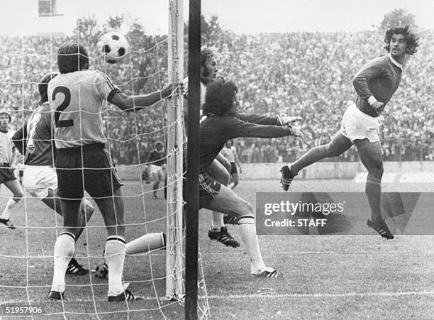 West German forward Gerd Mueller scores on a header past Australian goalkeeper Jack Reilly and defender Doug Utjesenovic during the World Cup first...