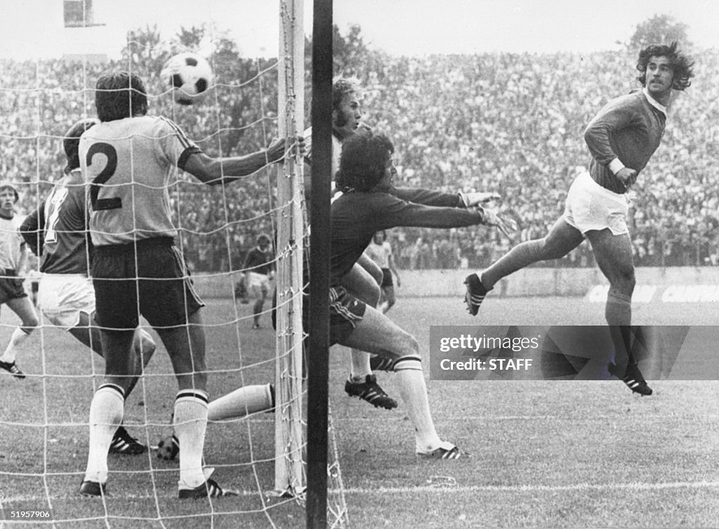 West German forward Gerd Mueller (R) scores on a h