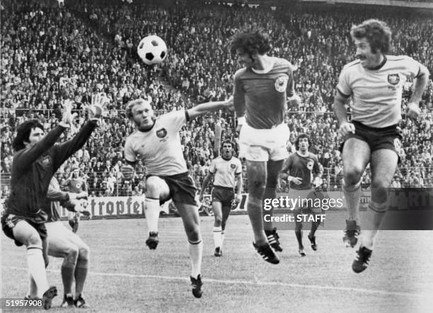 West German forward Gerd Mueller scores on a header past Australian goalkeeper Jack Reilly and defenders Manfred Schaefer and Ray Richards during the...