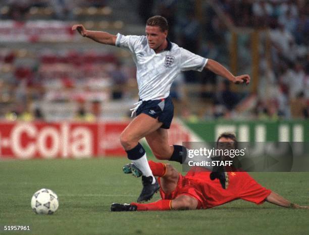 English midfielder Paul Gascoigne jumps over the attempted tackle of his Belgian counterpart Franky Van Der Elst during the World Cup second round...