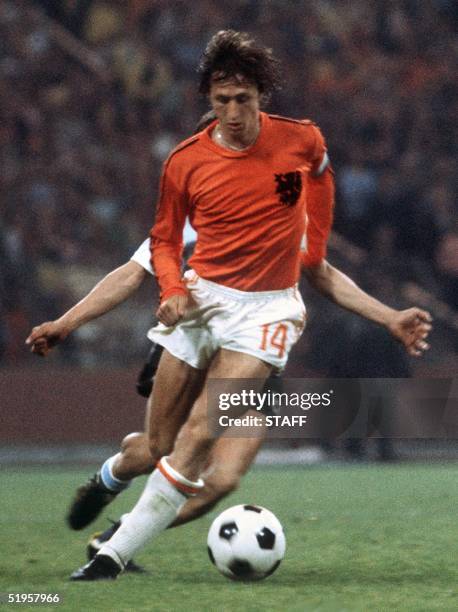 Dutch forward Johan Cruyff controls the ball under pressure from a West German player during the World Cup final between West Germany and the...