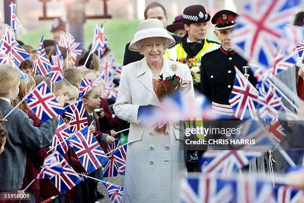 Britain's Queen Elizabeth II is greeted by crowds of wellwishers as she arrives in Woolwich, south east London, to visit the new reconstructed Queen...