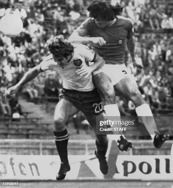 Chilean defender Elias Figueroa heads the ball over Australian forward Branko Buljevic during the World Cup first round soccer match between Chile...