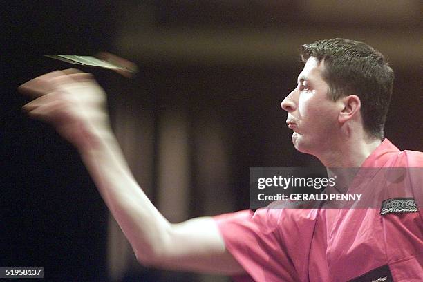 Austria's Mensur Suljovic in action 08 January 2002, during his second round World Championship Darts match against Mervyn King of England at the...