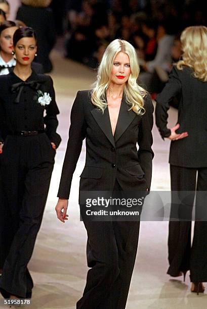 Top model Claudia Schiffer dressed with the famous Yves Saint Laurent tuxedo walks down the catwalk, 22 January 2002, during the retrospective part...