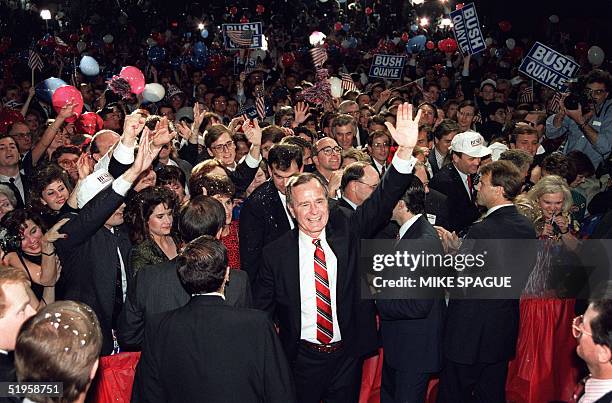 President-elect George Bush wades through the crowd 08 November 1988 following his acceptance speech at the Brown Convention Center, in Houston. AFP...