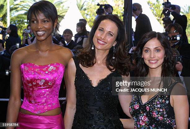 Top model and actress Andy Mac Dowell poses with Australian pop-singer Natalie Imbruglia and South African top model Primerose Moloantoa as they...