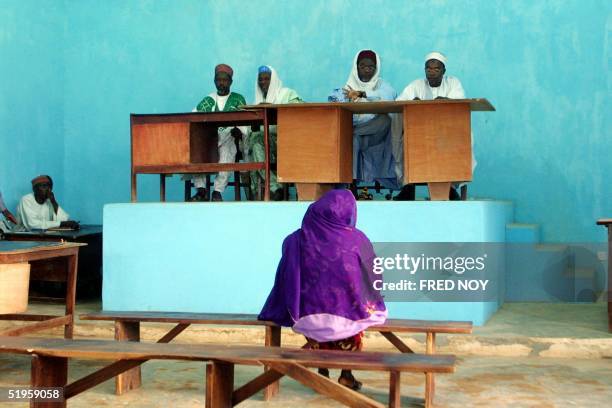 Picture dated 08 July 2002 shows divorcee Amina Lawal sitting on a bench facing judges of the Sharia Islamic court. The Funtua Upper Sharia court...