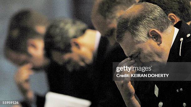 Assistant Chief Constable of Cambridgeshire police Keith Hoddy bows his head in prayer with colleagues during the memorial service at Ely cathedral...