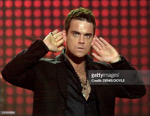English singer Robbie Williams performs during the MTV European Music Awards Thursday Nov. 14, 2002 in Barcelona's Sant Jordi palace, Spain. As...