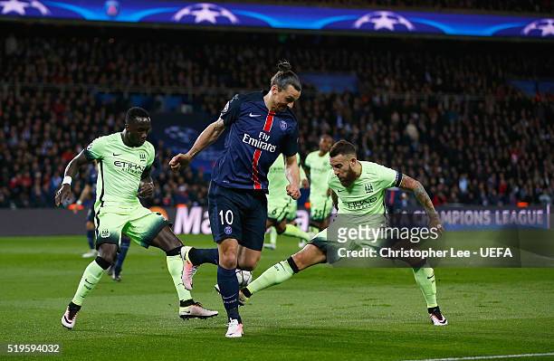 Zlatan Ibrahimovic of PSG back heels the ball as he battles with Bacary Sagna and Nicolás Otamendi of Man City during the UEFA Champions League...