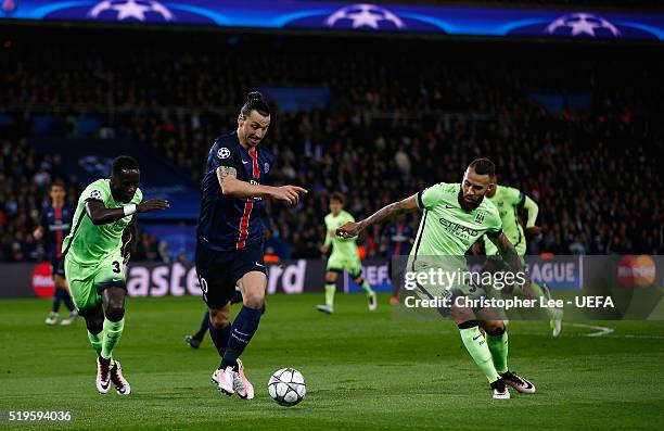 Zlatan Ibrahimovic of PSG battles with Bacary Sagna and Nicolás Otamendi of Man City during the UEFA Champions League Quarter Final First Leg match...