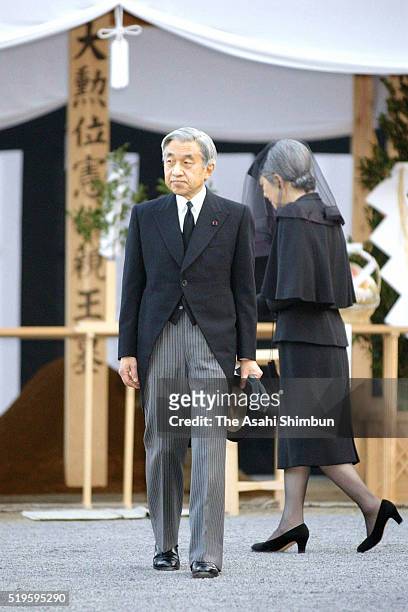 Emperor Akihito and Empress Michiko visit the grave of the late Prince Takamado at the Toshimagaoka Cemetery on November 30, 2002 in Tokyo, Japan.