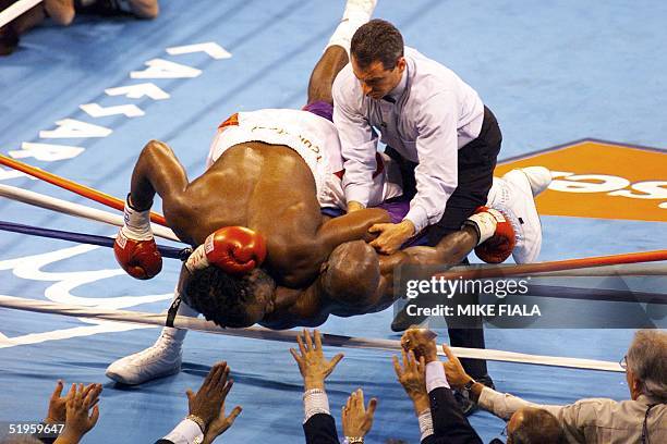 And IBF Heavyweight Champion Evander Holyfield from the U.S. Is crushed under WBC Heavyweight Champion Lennox Lewis from Great Britain during the...