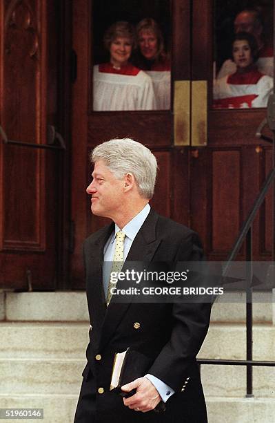 Members of the Foundry United Methodist Church choir watch as US President Bill Clinton departs following Sunday services 23 January 2000 in...