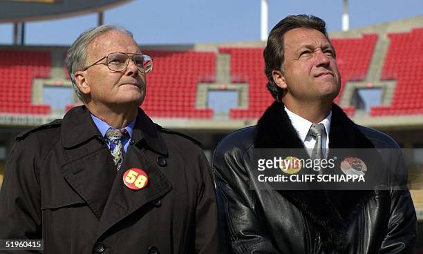 Kansas City Chiefs owner Lamar Hunt and team president Carl Peterson look to the sky as a US Air Force B-2 stealth bomber flew over Arrowhead Stadium...