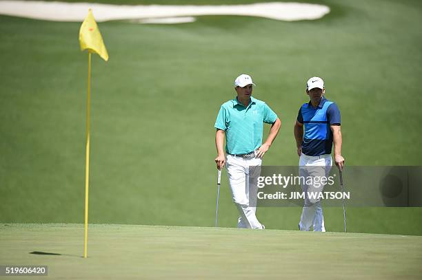 Golfer Jordan Spieth and England's Paul Casey wait to play their shots during Round 1 of the 80th Masters Golf Tournament at the Augusta National...