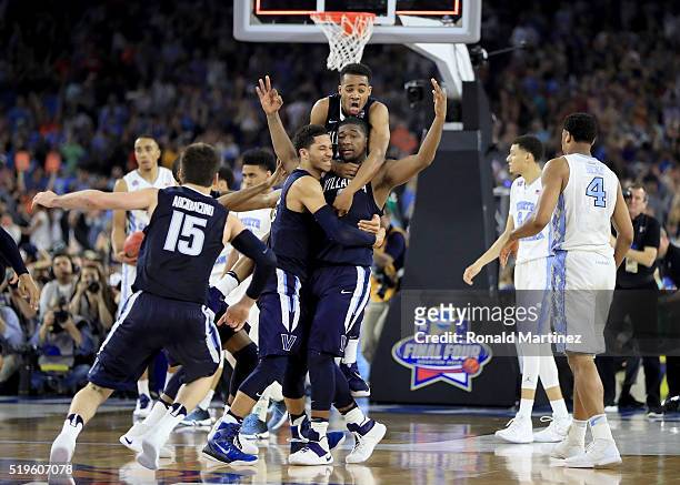 Kris Jenkins of the Villanova Wildcats celebrates with teammates after making the game-winning three pointer to defeat the North Carolina Tar Heels...