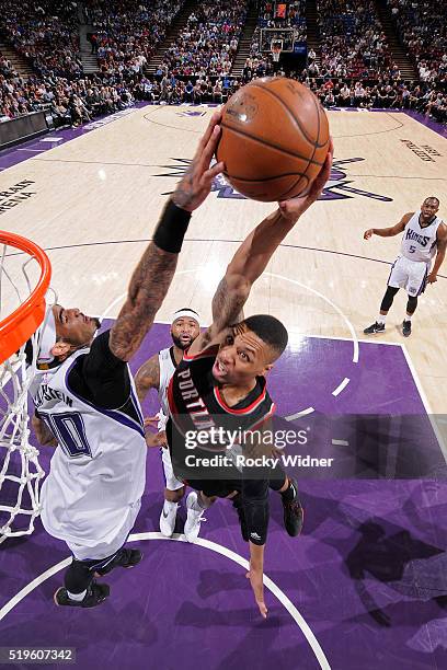 Damian Lillard of the Portland Trail Blazers dunks the ball while guarded by Willie Cauley-Stein of the Sacramento Kings at Sleep Train Arena on...