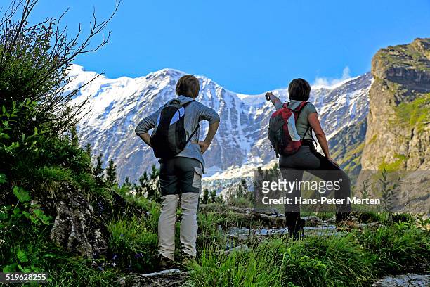 hiker at bäregg, bernese alps, switzerland - 2 dramatic landscape stock pictures, royalty-free photos & images