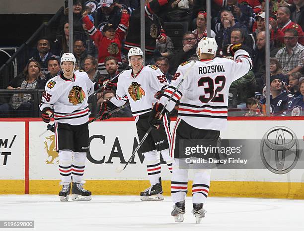 Dale Weise, Brandon Mashinter and Michal Rozsival of the Chicago Blackhawks celebrate a first period goal against the Winnipeg Jets at the MTS Centre...