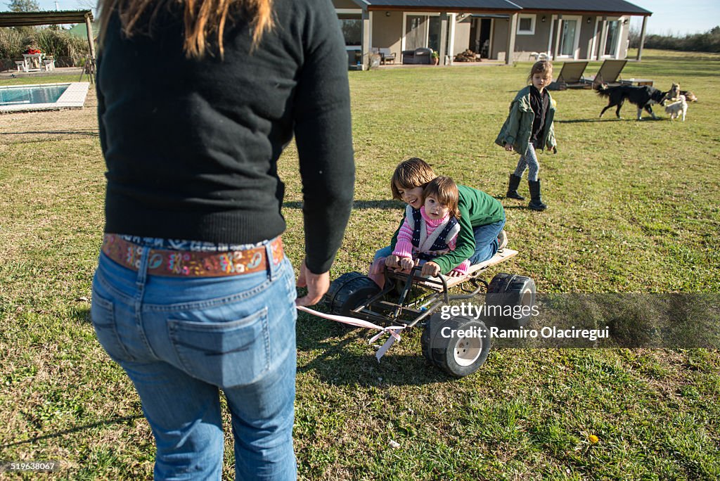 Mother taking kids on a cart