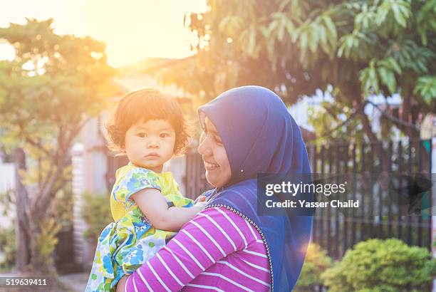 Mother Holding A Baby Girl