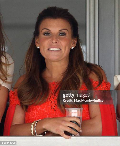 Coleen Rooney watches the racing as she attends day 1 'Grand Opening Day' of the Crabbie's Grand National Festival at Aintree Racecourse on April 7,...