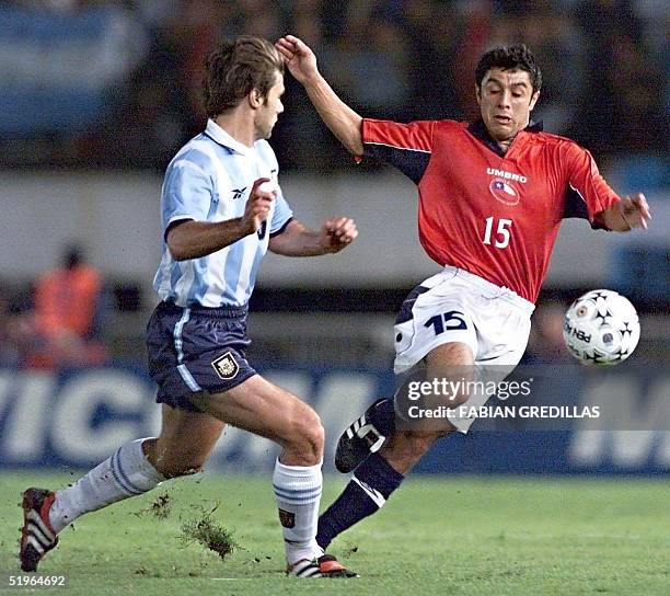 Chile's Rodrigo Tello takes the ball from Argentina's Mauricio Pochettino 29 March during their World Cup 2002 South American elimination match at...