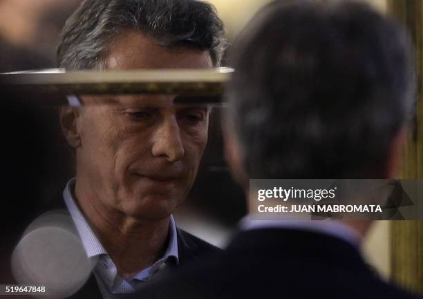 Argentine President Mauricio Macri is reflected in a mirror after delivering a speech at Casa Rosada Government Palace in Buenos Aires on April 7...