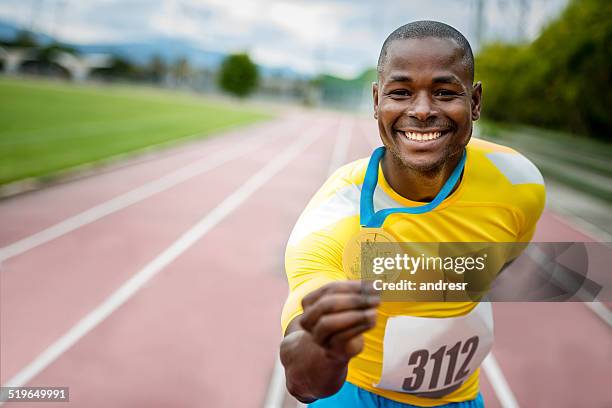 athlete with a gold medal - running medal stock pictures, royalty-free photos & images