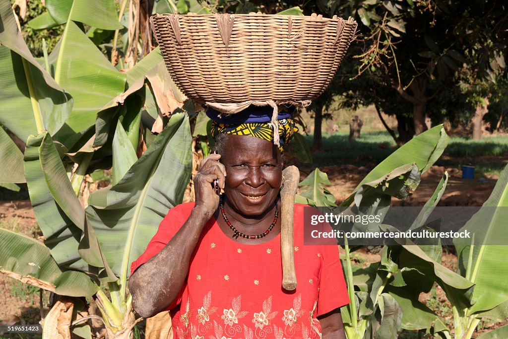 An old peasant woman using a mobile phone