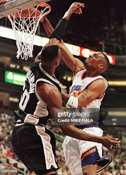 Phoenix Suns' guard Penny Hardaway slam dunks before San Antonio Spurs' center David Robinson during the first quarter of their Western Conference...