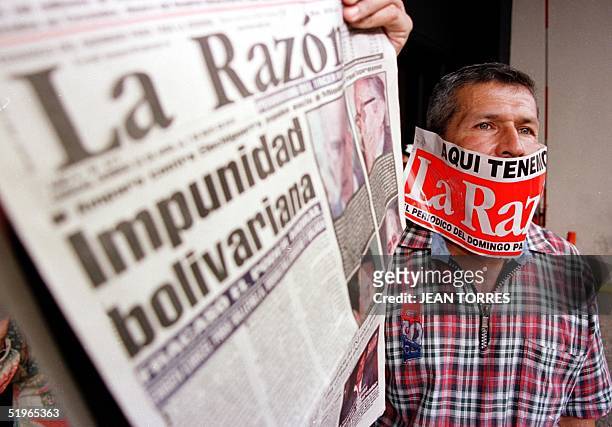 Venezuelan journalist shows a copy of the newspaper "The Reason" to protest the mistreatment of the press by President Hugo Chavez and to support the...