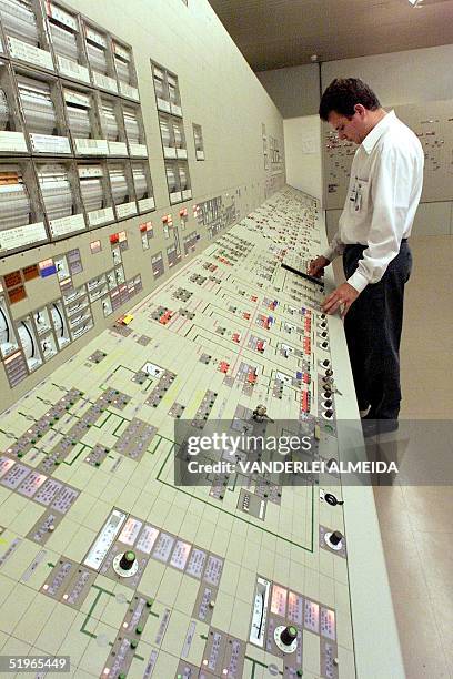 Jose Carlos Santos, control engineer at a nuclear power plant, looks at the equipment 11 May 2000 in Itaorna, near Rio de Janeiro. Jose Carlos...