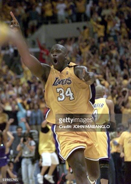 Los Angeles Lakers' Shaquille O'Neal raises his hands after scoring two points against the Portland Trail Blazers at the end of game seven of their...