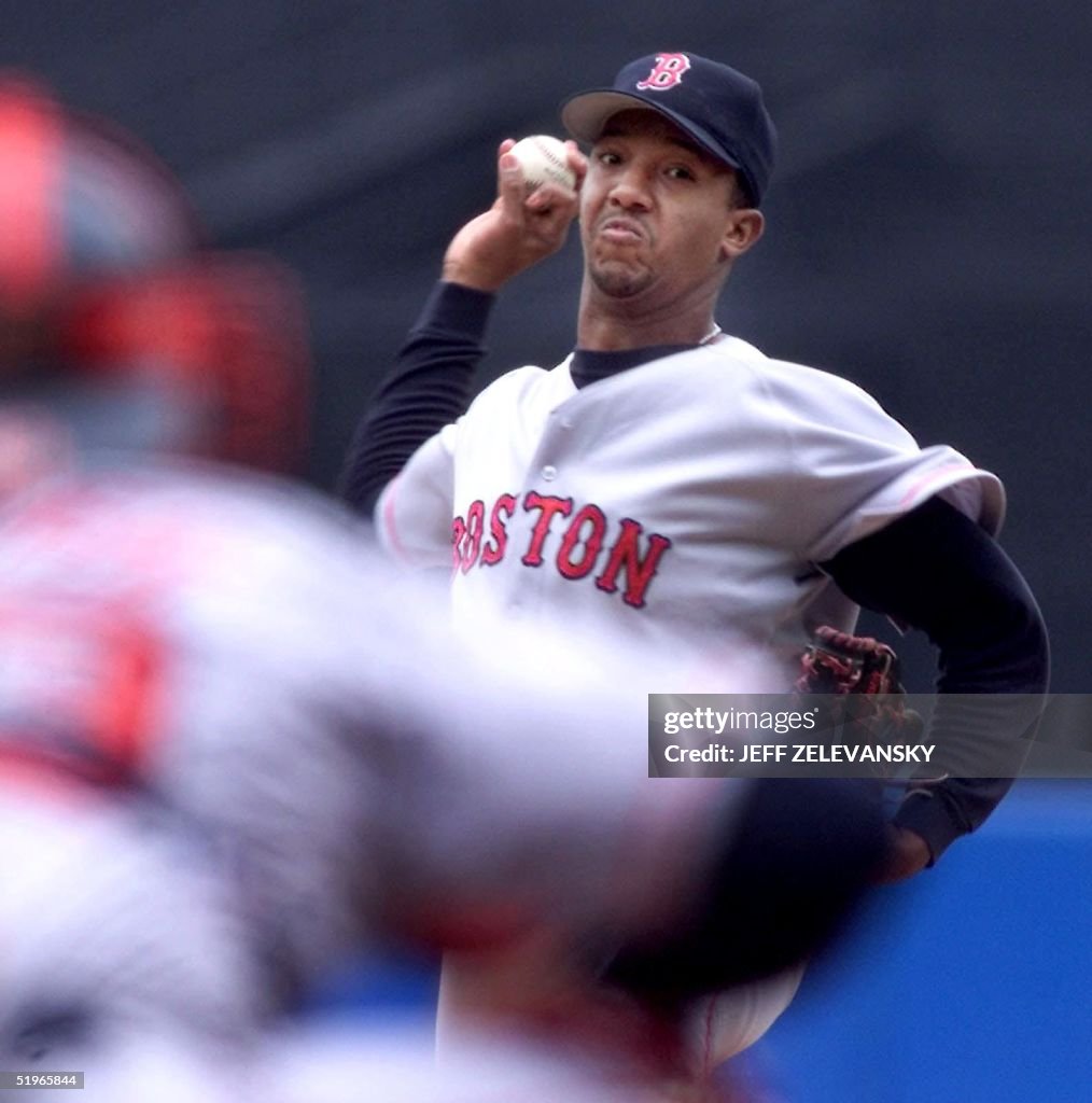 Boston Red Sox pitcher Pedro Martinez (R) throws t