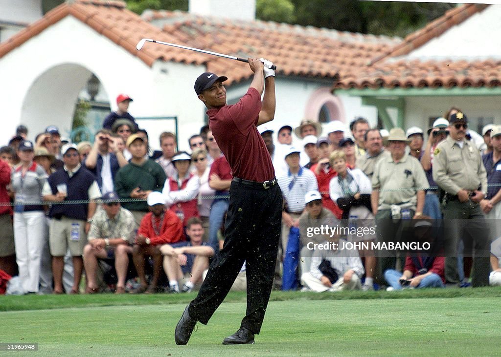 Tiger Woods of the US watches his approach shot on