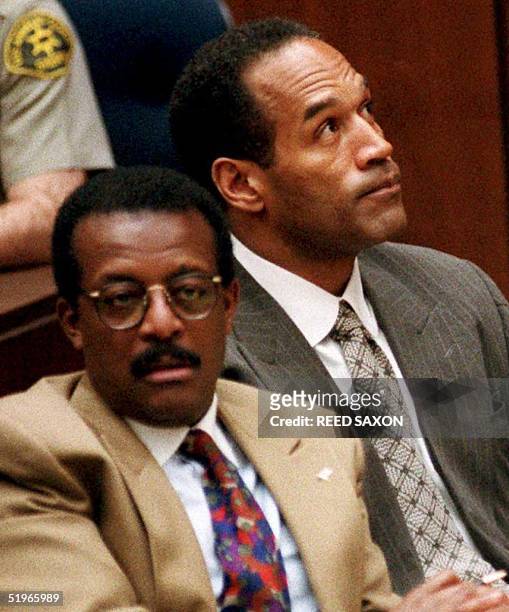 Simpson reacts as he and attorney Johnnie Cochran Jr. Listen during his murder trial 03 February 1995 in Los Angeles,CA, to testimony of Denise...