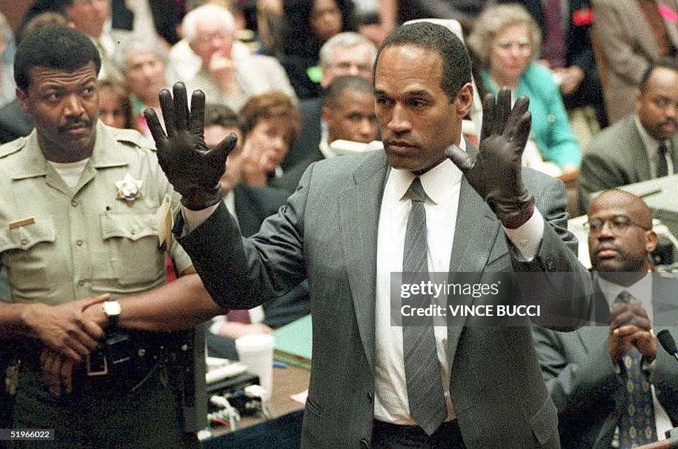 O.J. Simpson shows the jury a new pair of Aris ext