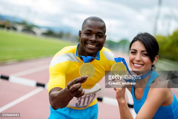 athletes with gold medals - marathon medal stock pictures, royalty-free photos & images
