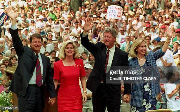 Democratic presidential candidate Bill Clinton , his wife Hillary , running mate Al Gore and his wife Tipper wave to supporters at the Chautauqua...