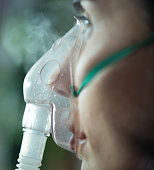 close up view of a woman  using nebuliser mask